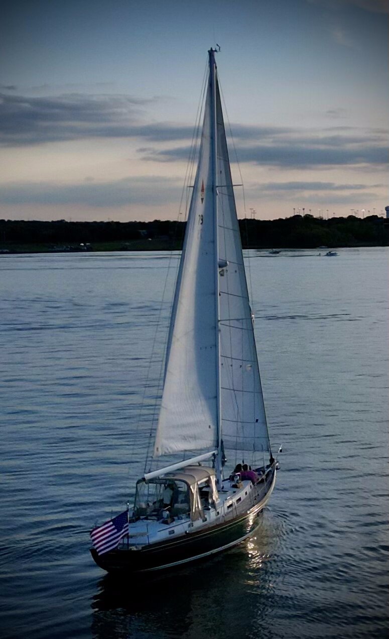 Sails silhouetted at night